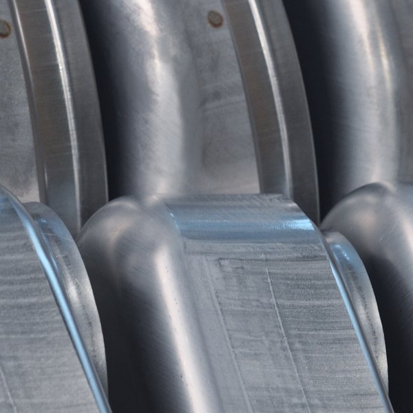 Several metal workpieces side by side, in a close-up view.
